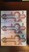 Front side showing portrait of Queen Elizabeth II and denomination 2 in sequential order