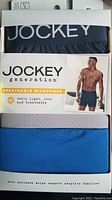 Boxer briefs packaged showing the brand Jockey Generation breathable microfiber in size XL, three pairs in blue, gray, and navy.