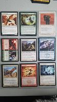 Photo showing all nine Magic: The Gathering cards laid out in a 3x3 grid to display card art and text.