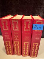 Four vintage Agatha Christie hardcover books in red with gold gilt design on spines including titles.
