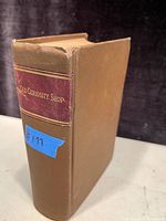 Brown hardcover book with maroon spine label showing the title Old Curiosity Shop