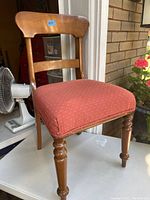 Photo showing front and side view of antique Victorian walnut side chair with red upholstered seat and turned front legs.