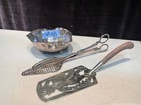 Photo showing all three items: nut dish, corn cob nutcracker, and cake server with wooden handle