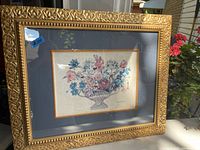 Signed floral print in an ornate gilded wood frame with blue mat, whole view showing condition and frame details.