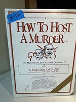Closed box of How to Host a Murder game titled 'A Matter of Faxe'. White box with theatrical mask graphic and game subtitle.