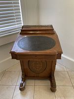 Front view of closed desk showing pedestal base and panel inlay