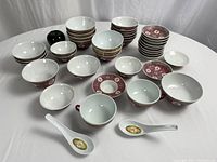 Large assortment of 30 porcelain pieces including bowls, cups, spoons, and saucers with traditional Asian design and patterns.
