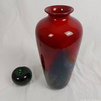 Full vase next to green glass apple for scale