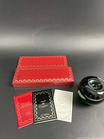 Original red Cartier box with three booklets and green glass apple for scale