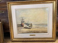 Framed full view of the painting showing three beached boats and dock at low tide.