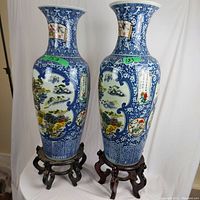 Full front view of both vases on stands against white background