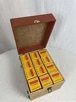 Open vintage storage case showing twelve unopened Kodak image cartridge boxes neatly arranged inside.