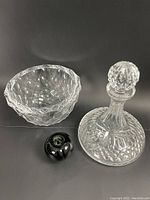 Photo showing the Waterford crystal ships decanter with stopper alongside the Orrefors crystal bowl and a green apple used for size reference.