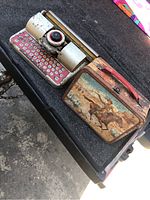Toy typewriter and lunchbox placed next to each other on a surface, showing overall lot contents.