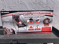 Front view of boxed arcade basketball game showing brand, model, key features and game image.