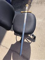 Full view of the sword laid across a chair to show full length and condition.