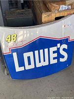 Close-up of 1/3 scale NASCAR hood showing Lowe's sponsorship, number 48, and Jimmie Johnson's signature.