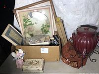 Overview of lot showing framed pictures, jewelry box, figurines, and beverage dispenser.