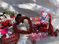 Photo showing various Valentine's Day plush toys, heart-shaped signs, and decorations.