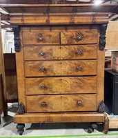 Front view of solid wood colonial style dresser showing five drawers with wood grain finish and three-piece construction.
