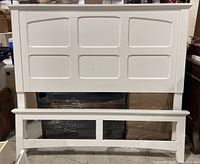 White wooden IKEA bed frame headboard and footboard with panel design.