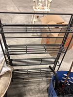 Metal 4-shelf steel rack with horizontal bars, black finish