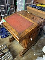 Top view showing red leather inset writing surface and wood top with wear