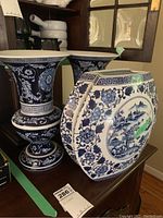 Three vases grouped on a wooden cabinet surface