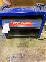 Front lower part with visible cutterhead safety warning label.