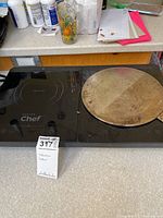 Overview photo showing the Master Chef induction cooktop with two cooking zones and the Von Chef round cooking tool placed on top.