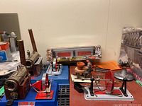 Two Wilesco steam engines, potter wheel and boxed M 57 accessory on black shelving