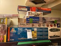 Boxes of Stinger .30 RC airplane kit, parts box, Revell Monogram B-17 Flying Fortress, Fokker Dr.1 triplane and Italeri Vosper MTB kits