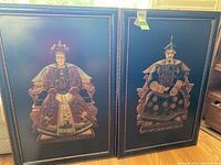 Both painted bas-relief panels side by side in black lacquer frames