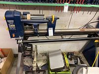 Overview of Mastercraft wood lathe on stand with miter saw and sander below
