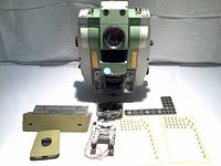 Leica TCRP1205 main body with separate metal base plate and small parts arranged in front showing condition and parts included