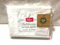 Photo of sealed packaging showing Endy pillowcase label with standard size indication and a tag about organic cotton certified by GOTS.