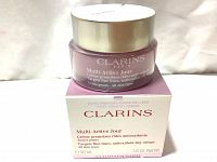 Photo of the Clarins Multi-Active Jour day cream jar on top of its box, showing product name and quantity 50ml, all skin types