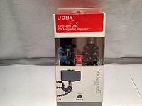 Front view of unopened Joby Grip Tight ONE GP Magnetic Impulse Gorillapod tripod in original retail packaging with clear display window showing tripod and mount inside.