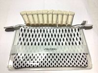 Clear pouch with black diamond pattern displayed with 10 foundation sample tubes above