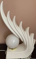Side view of white ceramic art deco style lamp