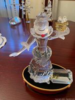 Front view of Colombine figurine showing detailed crystal dress and red accent jewel with the display base including the identification plaque.