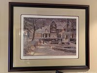 Frontal view of framed print showing snowy village scene and framing detail