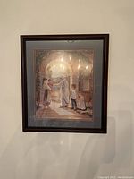 Framed and matted color print artwork by Trisha Romance titled "Journey of Hope" depicting a family scene under an archway, measuring 22.5"w x 25.5"h on a wall.
