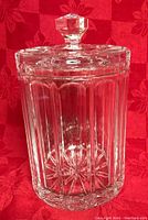 Clear cut crystal cookie jar with vertical panel cuts and faceted lid knob