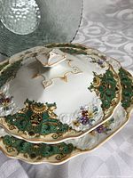 Close-up of the Myott Son & Co. covered vegetable bowl showing the detailed green, gold, and floral design and gold-accented handle on lid