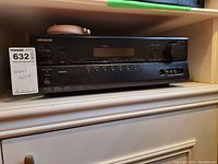 Front view of Onkyo TX-SR307 A/V Receiver showing brand logo, control knobs, buttons, and front display panel.