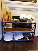 Front view of metal frame shelf holding various items not included in sale.