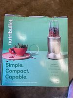 Full front view of the Nutribullet box showing the product image, brand, and marketing phrases.
