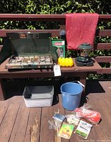 Photo showing all items in lot including propane stove, lantern, blue bucket, wash basin, red ground sheet, and accessories