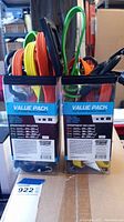 Two plastic containers packed with flat strap bungee cords in orange, yellow, green and black with plastic hooks.